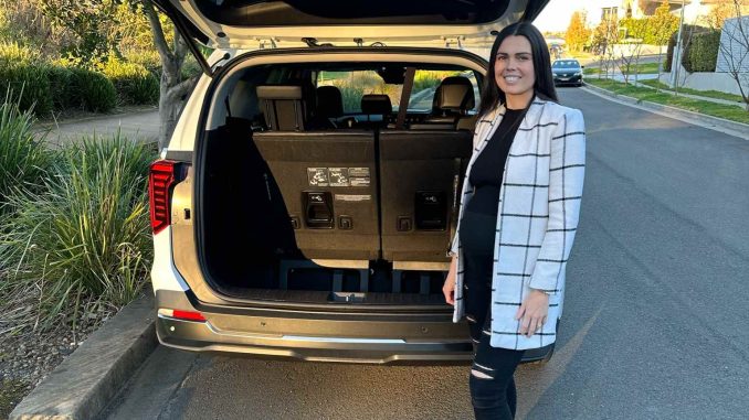 2025 Kia Carnival GT-Line hybrid boot with person 1