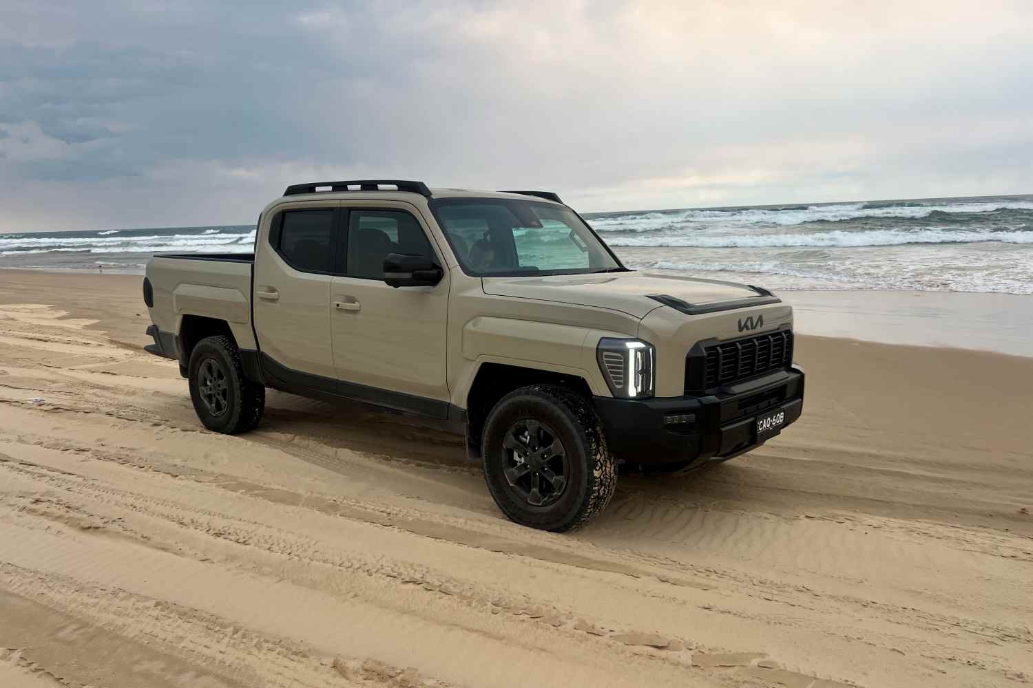 Kia Tasman X-Pro 4WD Ute front quarter on beach 1
