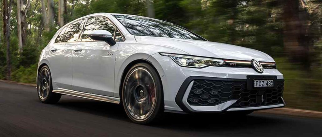 2026 VW Golf GTi front quarter driving view 1