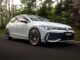 2026 VW Golf GTi front quarter driving view 1