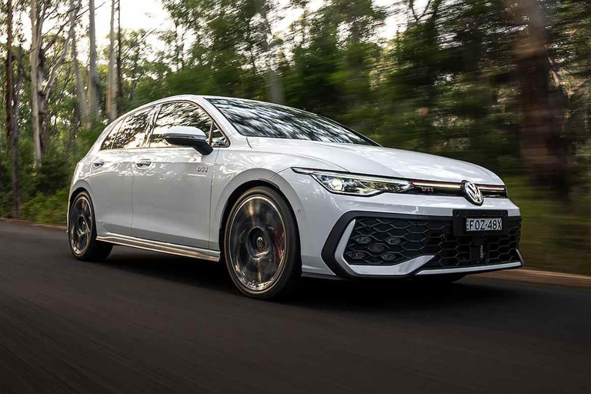 2026 VW Golf GTi front quarter driving view 1