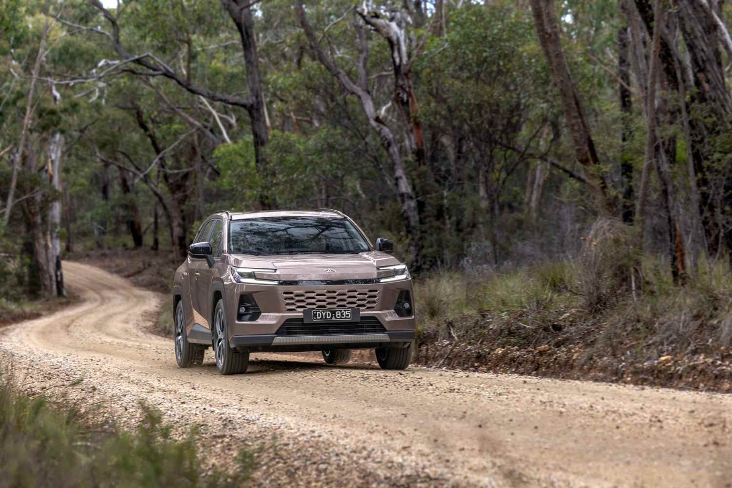 2026 Toyota RAV4 Cruiser AWD Hybrid front driving on dirt road 1