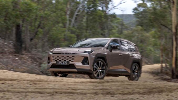 2026 Toyota RAV4 Cruiser AWD Hybrid front driving on dirt road 2